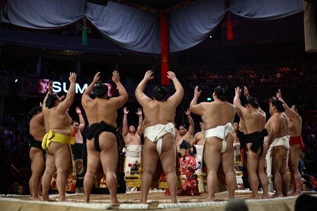 Rikishi take part in the ring entering ceremony on day 2 of the Grand Sumo Tournament at the Royal Albert Hall in central London on October 16, 2025. (Photo by HENRY NICHOLLS / AFP)