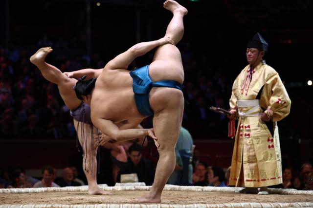 Tobizaru (L) and Kotoeiho (R) stamp the ground before their bout during the Grand Sumo Tournament at the Royal Albert Hall in central London on October 16, 2025. (Photo by HENRY NICHOLLS / AFP)