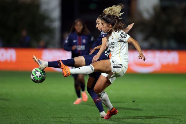 Paris Saint-Germain's Spanish defender #77 Olga Carmona (L) and Real Madrid's Spanish forward #11 Alba Redondo (R) fight for the ball during the UEFA Women's Champions League first round day 2 football match between Paris Saint-Germain (PSG) and Real Madrid at the Campus Paris Saint-Germain in Poissy, western Paris on October 16, 2025. (Photo by Franck FIFE / AFP)