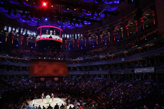 Wakamotoharu (L) faces Roga (R) during their bout on day 2 of the Grand Sumo Tournament at the Royal Albert Hall in central London on October 16, 2025. (Photo by HENRY NICHOLLS / AFP)
