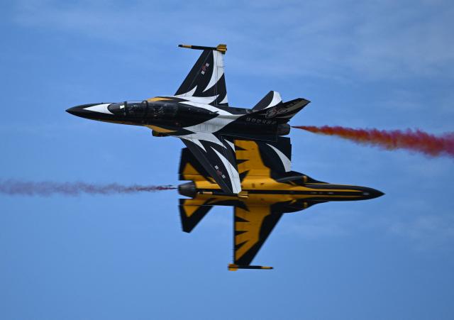 The Black Eagles, the aerobatic team of T-50 jets belonging to South Korea's Air Force, fly in formation during the Seoul International Aerospace and Defence Exhibition (ADEX) at a military airport in Seongnam on October 17, 2025. (Photo by Jung Yeon-je / AFP)