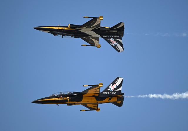 The Black Eagles, the aerobatic team of T-50 jets belonging to South Korea's Air Force, fly in formation during the Seoul International Aerospace and Defence Exhibition (ADEX) at a military airport in Seongnam on October 17, 2025. (Photo by Jung Yeon-je / AFP)