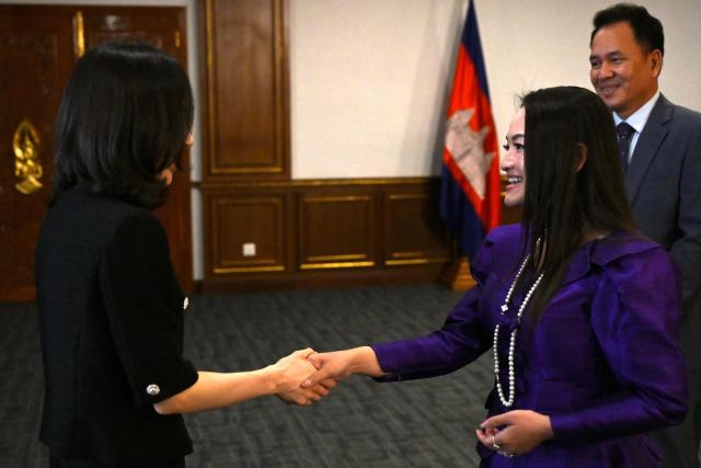 South Korea's Second Vice Foreign Minister Kim Jin-a (L) shakes hands with Cambodian Secretary of State, Ministry of Foreign Affairs and International Cooperation Yentieng Puthirasmey (R) during a meeting at the Ministry of Foreign Affairs and International Cooperation building in Phnom Penh on October 17, 2025. Two South Koreans detained in a crime crackdown by Cambodian authorities returned home on October 17, police said, a day after Phnom Penh announced plans to deport 59 Koreans accused of working in cyberscam operations. (Photo by TANG CHHIN Sothy / AFP)