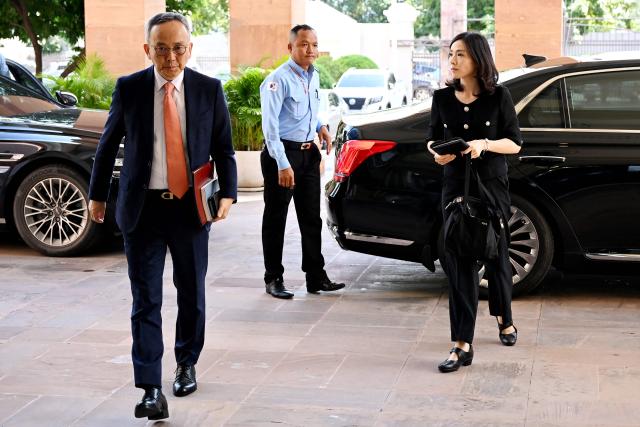 South Korea's Second Vice Foreign Minister Kim Jin-a (R) arrives for a meeting at the Ministry of Foreign Affairs and International Cooperation building in Phnom Penh on October 17, 2025. Two South Koreans detained in a crime crackdown by Cambodian authorities returned home on October 17, police said, a day after Phnom Penh announced plans to deport 59 Koreans accused of working in cyberscam operations. (Photo by TANG CHHIN Sothy / AFP)