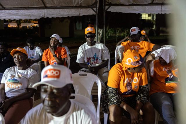 Supporters of Ivorian President and presidential candidate for Rally of Houphouetists for Democracy and Peace (RHDP) Alassane Ouattara look on during a political gathering ahead of the upcoming presidential election in Cocody near Abidjan on October 16, 2025. (Photo by EMMANUEL CROSET / AFP)