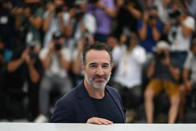 (FILES) French actor Jean Dujardin poses during a photocall for the film "OSS 117 : From Africa With Love (OSS 117 : Alerte Rouge en Afrique Noire)" at the 74th edition of the Cannes Film Festival in Cannes, southern France, on July 17, 2021. In ‘The Man Who Shrunk’, in cinemas on October 22, 2025, Jean Dujardin takes on a daunting challenge, appearing alone on screen for much of this fantasy tale that revisits the 1957 cult film. (Photo by CHRISTOPHE SIMON / AFP)