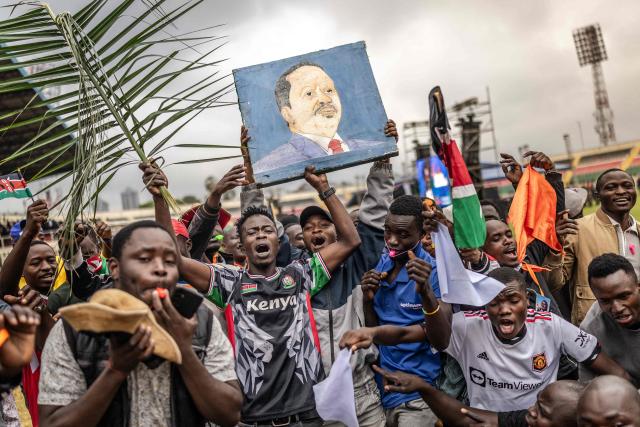Mourners and supporters of Kenyas opposition leader and former Prime Minister Raila Odinga chant slogans and hold a painting bearing his portrait as they gather ahead of his State Funeral at Nyayo Stadium in Nairobi on October 17, 2025. Kenyan opposition leader Raila Odinga has died at the age of 80 during a health visit to India, local police said on October 15, 2025. Odinga was the perennial opposition figure of Kenyan politics, running unsuccessfully for the presidency on five occasions, most recently in 2022. He remained a dominant force, able to rally huge numbers, particularly from his native western Kenya. (Photo by Luis TATO / AFP)