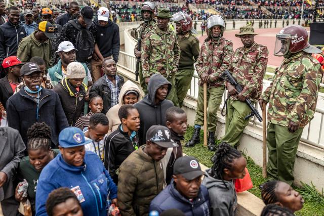Kenya police officers monitor access to the venue as mourners and supporters of opposition leader and former Prime Minister Raila Odinga arrive ahead of his State Funeral at Nyayo Stadium in Nairobi on October 17, 2025. Kenyan opposition leader Raila Odinga has died at the age of 80 during a health visit to India, local police said on October 15, 2025. Odinga was the perennial opposition figure of Kenyan politics, running unsuccessfully for the presidency on five occasions, most recently in 2022. He remained a dominant force, able to rally huge numbers, particularly from his native western Kenya. (Photo by Luis TATO / AFP)