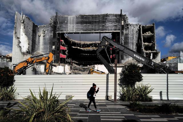 (FILES) A woman walks in front of The "Theatre National de Nice" (TNN) during demolition work on the french riviera city of Nice, on December 10, 2022. Behind the Promenade des Anglais, Nice's mayor Christian Estrosi will inaugurate the final section of the Promenade du Paillon on October 18, 2025, a long stretch of greenery that has transformed the centre of Nice, at an exorbitant cost, according to critics of the mayor. (Photo by Valery HACHE / AFP)