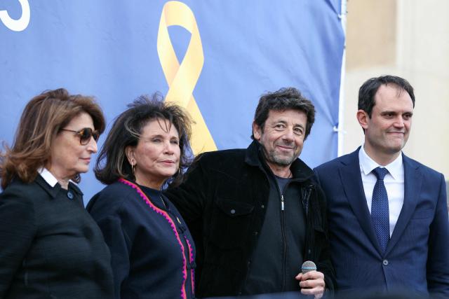 (From R) The President of the Representative Council of Jewish Institutions in France (CRIF) Yonathan Arfi, French singer and actor Patrick Bruel and French journalist Anne Sinclair on stage after giving a speech during a rally organized by the CRIF in support of Israeli hostages and in the memory of the victims of the October 7, 2023, in front of the Trocadero in Paris, on October 17, 2025. (Photo by Alain JOCARD / AFP)