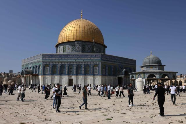 Muslim worshippers walk next to the Dome of the Rock mosque at the Al-Aqsa mosque compound in Jerusalem's Old City on October 17, 2025. (Photo by AHMAD GHARABLI / AFP)