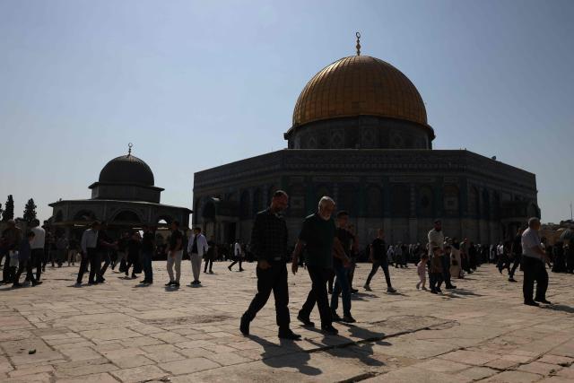 Muslim worshippers walk next to the Dome of the Rock mosque at the Al-Aqsa mosque compound in Jerusalem's Old City on October 17, 2025. (Photo by AHMAD GHARABLI / AFP)