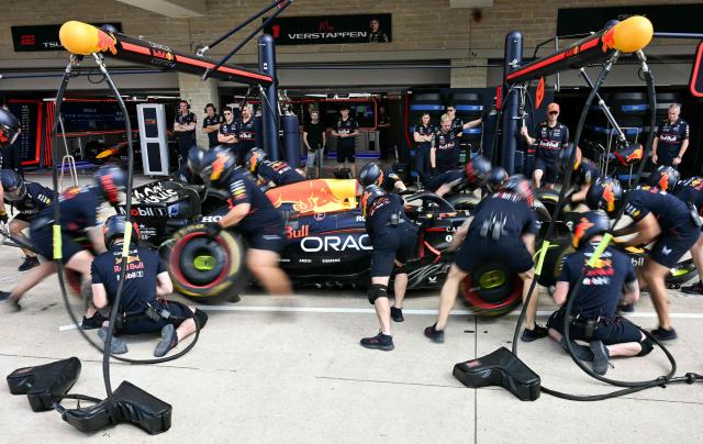 Red Bull technicians work on the car of Red Bull Racing's Dutch driver Max Verstappen in pit lane during the practice session for the United States Formula One Grand Prix at the Circuit of the Americas in Austin, Texas, on October 17, 2025. (Photo by Jim WATSON / AFP)