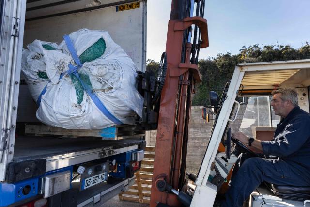 Fishnets are loaded into a lorry after being collected by French charity association "Kernic Solidarites" to be send to Ukraine and use as protections against drone attacks, in the Britany port of Roscoff, on October 17, 2025. (Photo by Fred TANNEAU / AFP)