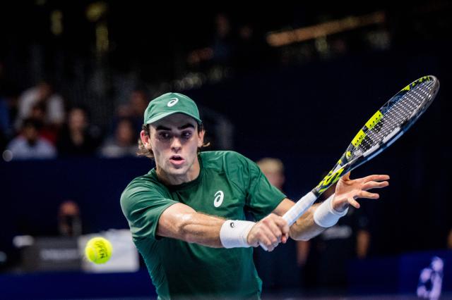 US' Eliot Spizzirri returns a ball to Canada's  Felix Auger-Aliassime during their singles quarter-final match of the ATP European Open tennis tournament in Brussels, on October 17, 2025. (Photo by JASPER JACOBS / Belga / AFP) / Belgium OUT