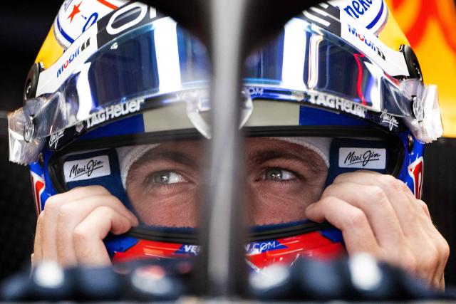 Red Bull Racing's Dutch driver Max Verstappen secures his helmet as he sits in his car in the garage during the practice session for the United States Formula One Grand Prix at the Circuit of the Americas in Austin, Texas, on October 17, 2025. (Photo by Jim WATSON / AFP)