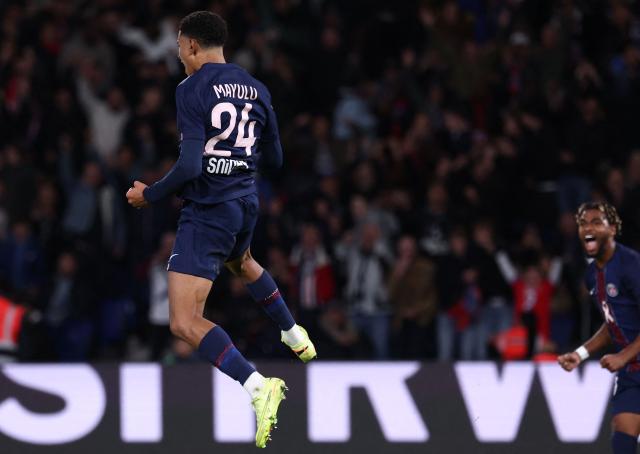 Paris Saint-Germain's French midfielder #24 Senny Mayulu (L) leaps in the air as he celebrates after scoring PSG's third goal during the French L1 football match between Paris Saint-Germain (PSG) and RC Strasbourg Alsace at the Parc des Princes Stadium in Paris on October 17, 2025. (Photo by FRANCK FIFE / AFP)