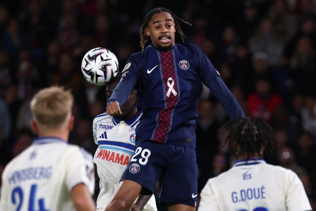 Paris Saint-Germain's French forward #29 Bradley Barcola leaps in the air as he fights for the ball during the French L1 football match between Paris Saint-Germain (PSG) and RC Strasbourg Alsace at the Parc des Princes Stadium in Paris on October 17, 2025. (Photo by FRANCK FIFE / AFP)