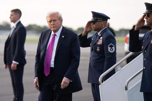 US President Donald Trump disembarks from Air Force One upon arrival at Palm Beach International Airport in West Palm Beach, Florida, October 17, 2025, as he travels to Mar-a-Lago for the weekend. (Photo by SAUL LOEB / AFP)