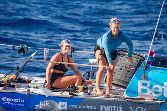 British rowers Jess Rowe (R) and Miriam Payne pause while rowing in their vessel named "Velocity" as they approach Australia's Great Barrier Reef in the Coral Sea on October 17, 2025. The pair left Peru on May 5 to travel the 9,000 miles (14,500 kilometres) journey across the Pacific Ocean to Australia, raising money for charity and attempting to become the first women's team and the first pair to row across the Pacific Ocean non-stop and unsupported. (Photo by Brian CASSEY / AFP)