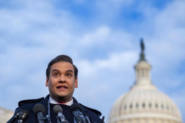 (FILES) US Representative George Santos (R-NY) speaks during a press conference outside the US Capitol in Washington, DC, on November 30, 2023. President Donald Trump on October 17, 2025 commuted the sentence of disgraced former Republican lawmaker George Santos, who was convicted of committing wire fraud and identity theft to splurge on lavish vacations and Botox injections with funds stolen from campaign donors. (Photo by Jim WATSON / AFP)