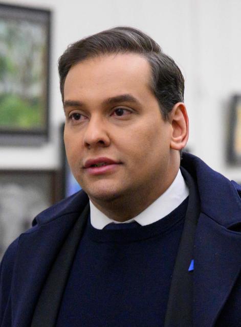 (FILES) Rep. George Santos, R-NY, walks from his office to the US Capitol in Washington, DC, on December 1, 2023. President Donald Trump on October 17, 2025 commuted the sentence of disgraced former Republican lawmaker George Santos, who was convicted of committing wire fraud and identity theft to splurge on lavish vacations and Botox injections with funds stolen from campaign donors. (Photo by Mandel NGAN / AFP)