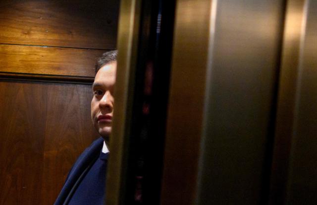 (FILES) Rep. George Santos, R-NY, takes an elevator while on his way from his office to the US Capitol in Washington, DC, on December 1, 2023. President Donald Trump on October 17, 2025 commuted the sentence of disgraced former Republican lawmaker George Santos, who was convicted of committing wire fraud and identity theft to splurge on lavish vacations and Botox injections with funds stolen from campaign donors. (Photo by Mandel NGAN / AFP)