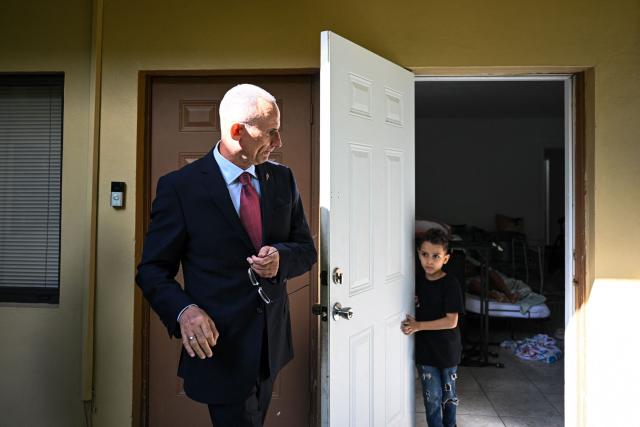 Daniel Jose Ferrer Aurtega, 6, (R) son of Cuban dissident Jose Daniel Ferrer (L), stands in the doorway as his father arrives at his house in Miami, Florida, on October 16, 2025. There's no rest for Jose Daniel Ferrer, a Cuban dissident who arrived in the United States on October 13 and is determined to work with other exiles to democratically unseat the communist government in Havana. "We have to be proactive if we want to encourage Cubans to fight for their rights, for their freedom, instead of leaving the country with a 'save yourself if you can' type of mentality," the longtime activist told AFP from his new home in Miami. (Photo by CHANDAN KHANNA / AFP)