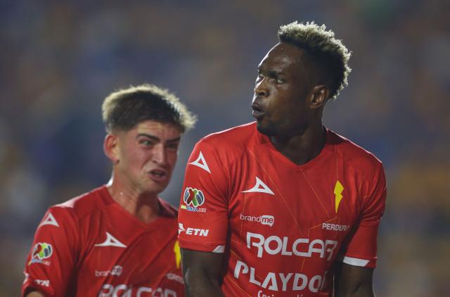Necaxa's Colombian forward #27 Diber Cambindo (front) celebrates after scoring the opening goal during the Liga MX Apertura tournament football match between Tigres and Necaxa at the University stadium -aka El Volcan- in San Nicolas de los Garza, Nuevo Leon, Mexico on October 17, 2025. (Photo by Julio Cesar AGUILAR / AFP)