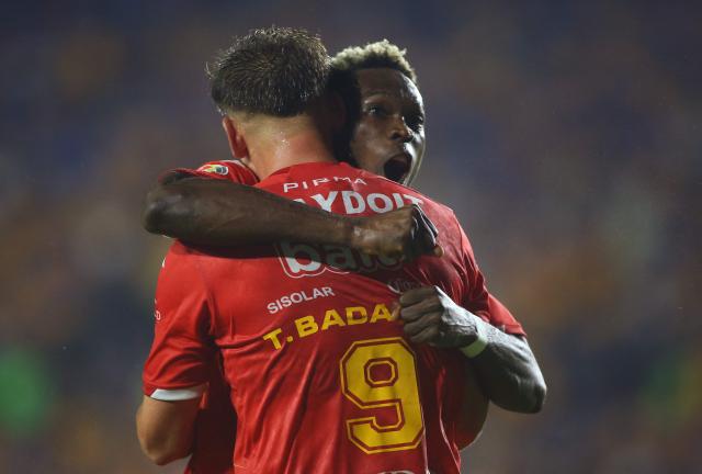 Necaxa's Colombian forward #27 Diber Cambindo (R) celebrates with teammate Necaxa's forward #09 Tomas Badaloni after scoring his second goal during the Liga MX Apertura tournament football match between Tigres and Necaxa at the University stadium -aka El Volcan- in San Nicolas de los Garza, Nuevo Leon, Mexico on October 17, 2025. (Photo by Julio Cesar AGUILAR / AFP)