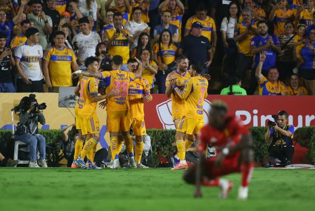 Tigres players celebrate their third goal during the Liga MX Apertura tournament football match between Tigres and Necaxa at the University stadium -aka El Volcan- in San Nicolas de los Garza, Nuevo Leon, Mexico on October 17, 2025. (Photo by Julio Cesar AGUILAR / AFP)