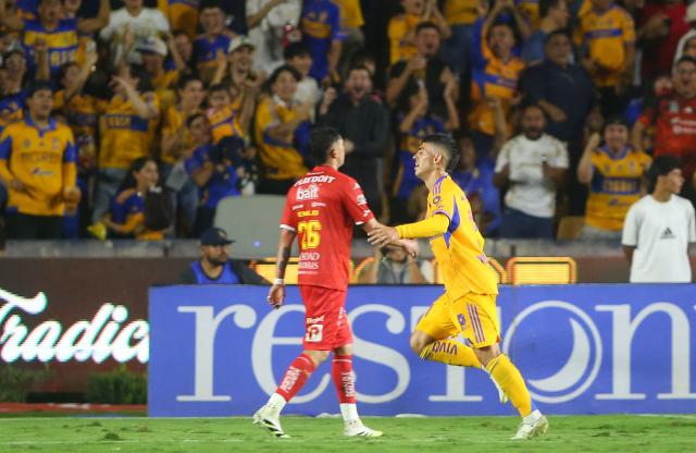Tigres' Argentine midfielder #11 Juan Brunetta celebrates his hat-trick during the Liga MX Apertura tournament football match between Tigres and Necaxa at the University stadium -aka El Volcan- in San Nicolas de los Garza, Nuevo Leon, Mexico on October 17, 2025. (Photo by Julio Cesar AGUILAR / AFP)