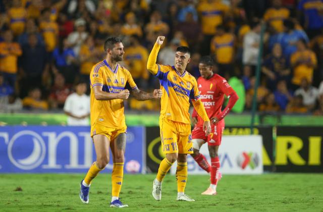 Tigres' Argentine midfielder #11 Juan Brunetta celebrates his hat-trick with teammate French forward #10 Andre-Pierre Gignac during the Liga MX Apertura tournament football match between Tigres and Necaxa at the University stadium -aka El Volcan- in San Nicolas de los Garza, Nuevo Leon, Mexico on October 17, 2025. (Photo by Julio Cesar AGUILAR / AFP)