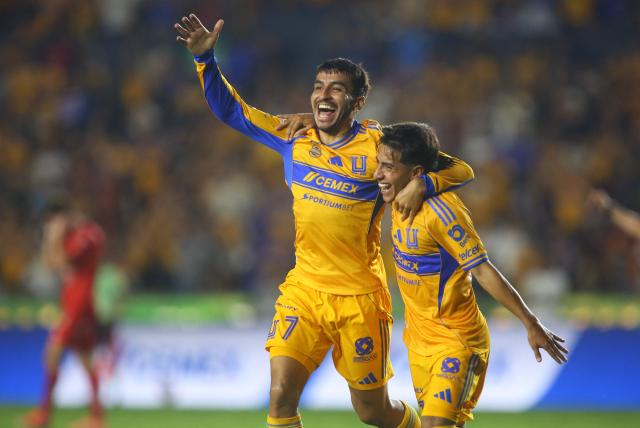 Tigres' Argentine forward (L) #07 Angel Correa celebrates after scoring his team's fourth goal with teammate forward #197 Diego Sanchez during the Liga MX Apertura tournament football match between Tigres and Necaxa at the University stadium -aka El Volcan- in San Nicolas de los Garza, Nuevo Leon, Mexico on October 17, 2025. (Photo by Julio Cesar AGUILAR / AFP)