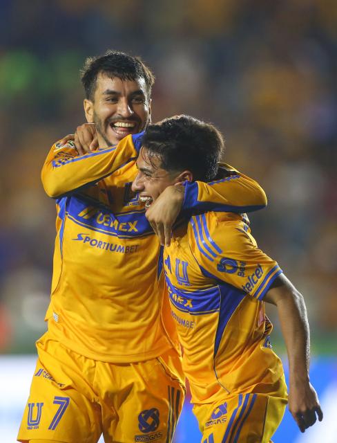 Tigres' Argentine forward (L) #07 Angel Correa celebrates after scoring his team's fourth goal with teammate forward #197 Diego Sanchez during the Liga MX Apertura tournament football match between Tigres and Necaxa at the University stadium -aka El Volcan- in San Nicolas de los Garza, Nuevo Leon, Mexico on October 17, 2025. (Photo by Julio Cesar AGUILAR / AFP)