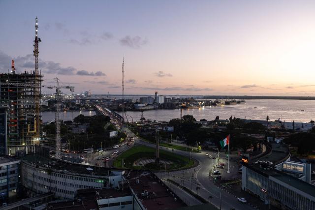 A general view of place de la republic, the pont Félix Houphouet Boigny and the autonomous port of Abidjan from Plateau near Abidjan on October 17, 2025. (Photo by EMMANUEL CROSET / AFP)