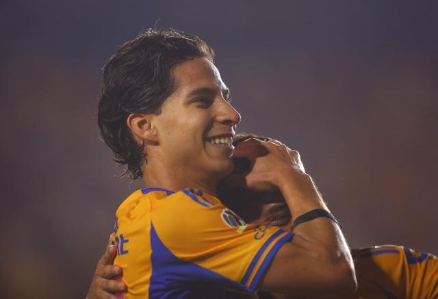 Tigres' midfielder #16 Diego Lainez celebrates after scoring his team's fifth goal with teammate forward #197 Diego Sanchez during the Liga MX Apertura tournament football match between Tigres and Necaxa at the University stadium -aka El Volcan- in San Nicolas de los Garza, Nuevo Leon, Mexico on October 17, 2025. (Photo by Julio Cesar AGUILAR / AFP)