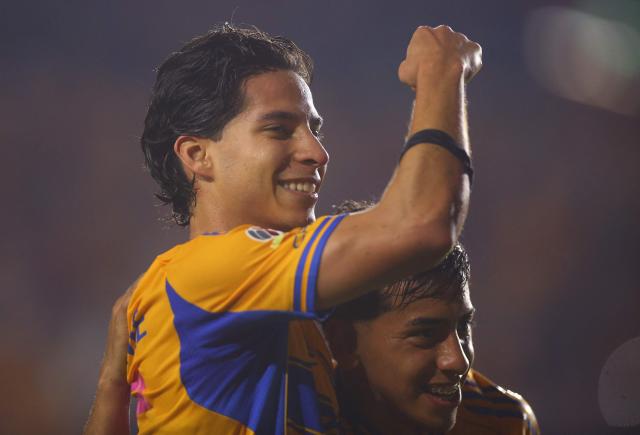 Tigres' midfielder #16 Diego Lainez celebrates after scoring his team's fifth goal with teammate forward #197 Diego Sanchez during the Liga MX Apertura tournament football match between Tigres and Necaxa at the University stadium -aka El Volcan- in San Nicolas de los Garza, Nuevo Leon, Mexico on October 17, 2025. (Photo by Julio Cesar AGUILAR / AFP)