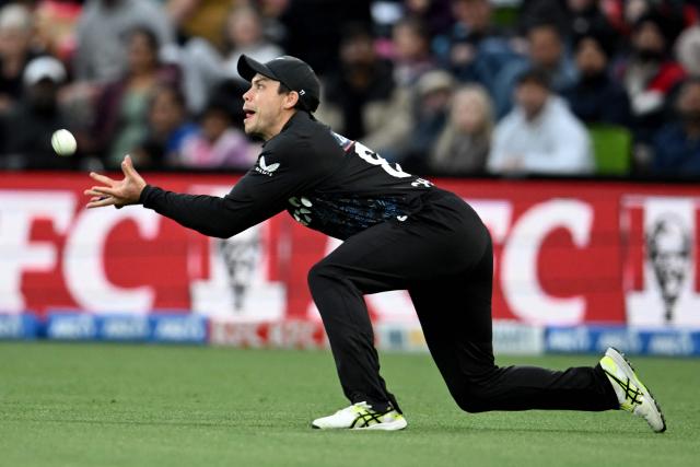 New Zealand's Mark Chapman catches the ball to dismiss England's Phil Salt during the first Twenty20 international cricket match between New Zealand and England at Hagley Oval in Christchurch on October 18, 2025. (Photo by Sanka VIDANAGAMA / AFP)