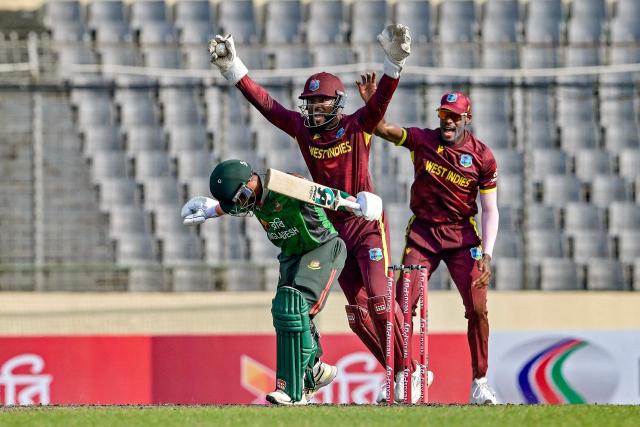 West Indies' captain and wicketkeeper Shai Hope (C) unsuccessfully appeals for leg before wicket (LBW) against Bangladesh's Mahidul Islam Ankon (L) during the first one-day international (ODI) cricket match between Bangladesh and West Indies at the Sher-e-Bangla National Cricket Stadium in Dhaka on October 18, 2025. (Photo by Munir UZ ZAMAN / AFP)