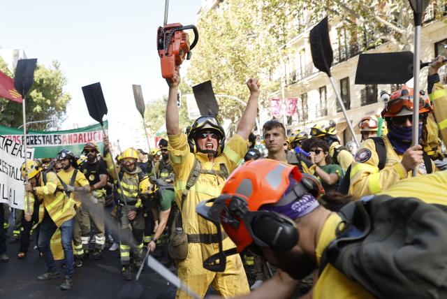 Spanish firefighters take part in a protest demanding for more resources in Madrid on October 18, 2025. (Photo by Oscar DEL POZO / AFP)