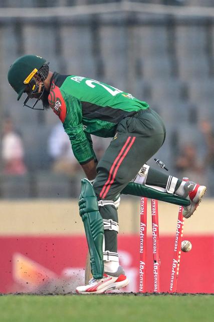 Bangladesh's Rishad Hossain is clean bowled by West Indies's Jayden Seales during the first one-day international (ODI) cricket match between Bangladesh and West Indies at the Sher-e-Bangla National Cricket Stadium in Dhaka on October 18, 2025. (Photo by Munir UZ ZAMAN / AFP)