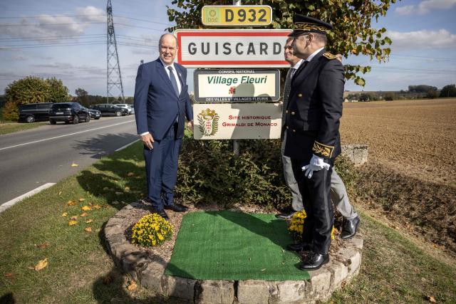 Prince Albert II of Monaco (L) poses with Guiscard mayor Thibault Delavenne and Compiegne's subprefect Christian Guyard (R) after unveiling a plaque marking the city's as member of the Grimaldi Monaco historical sites, in Guiscard on October 18, 2025. (Photo by Guillaume BAPTISTE / AFP)
