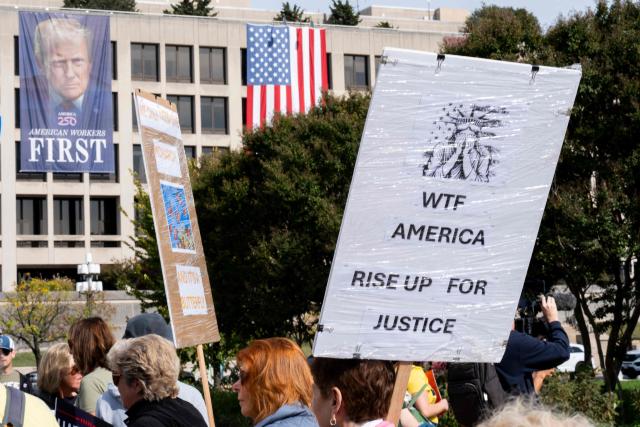 People participate in a "No Kings" national day of protest in New York on October 18, 2025. From New York to San Francisco, millions of Americans are expected to hit the streets to voice their anger over President Donald Trump's policies at nationwide "No Kings" protests. (Photo by Roberto Schmidt / AFP)
