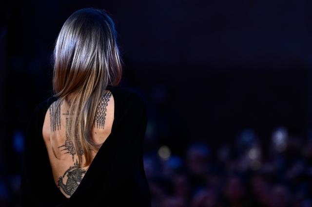 A picture shows the tattoos of US actress Angelina Jolie as she poses on the red carpet for the movie "Couture" during the 20th International Rome Film Festival (Festa del Cinema di Roma) in Rome, on October 18, 2025. (Photo by Tiziana FABI / AFP)