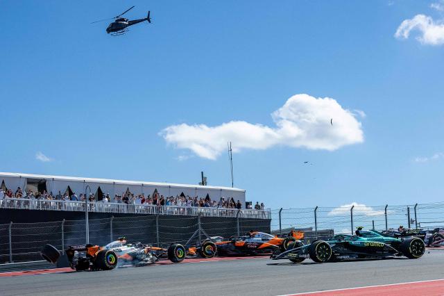 (L/R) McLaren's British driver Lando Norris and McLaren's Australian driver Oscar Piastri are involved in a crash during the United States Formula One Sprint at the Circuit of the Americas in Austin, Texas, on October 18, 2025. (Photo by Jim WATSON / AFP)