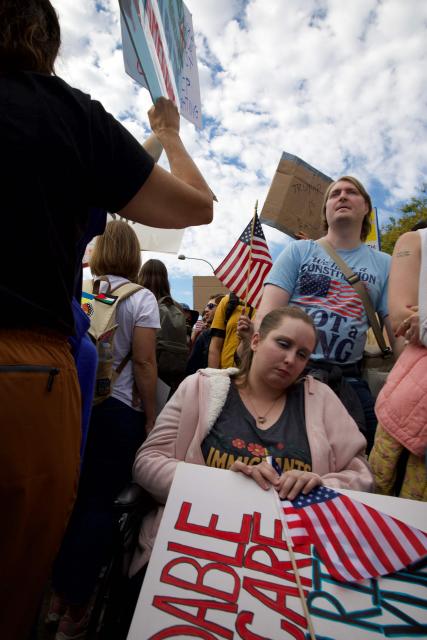 People participate in a "No Kings" national day of protest in Washington, DC, on October 18, 2025. From New York to San Francisco, millions of Americans are expected to hit the streets to voice their anger over President Donald Trump's policies at nationwide "No Kings" protests. (Photo by Amid FARAHI / AFP)