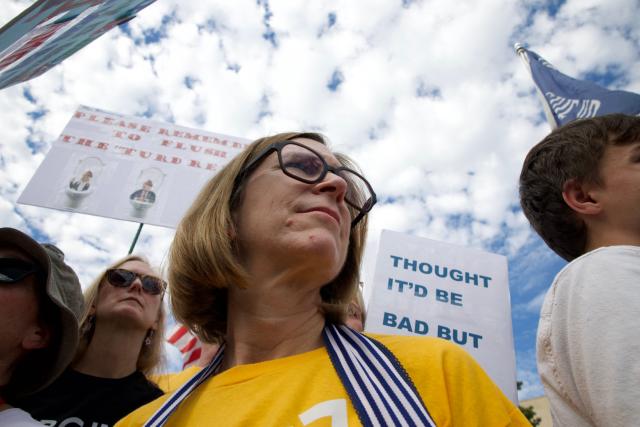 People participate in a "No Kings" national day of protest in Washington, DC, on October 18, 2025. From New York to San Francisco, millions of Americans are expected to hit the streets to voice their anger over President Donald Trump's policies at nationwide "No Kings" protests. (Photo by Amid FARAHI / AFP)