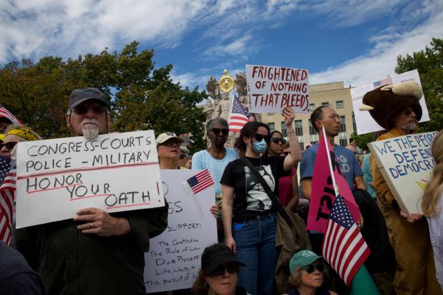 People participate in a "No Kings" national day of protest in Washington, DC, on October 18, 2025. From New York to San Francisco, millions of Americans are expected to hit the streets to voice their anger over President Donald Trump's policies at nationwide "No Kings" protests. (Photo by Amid FARAHI / AFP)