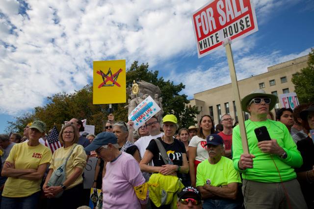 People participate in a "No Kings" national day of protest in Washington, DC, on October 18, 2025. From New York to San Francisco, millions of Americans are expected to hit the streets to voice their anger over President Donald Trump's policies at nationwide "No Kings" protests. (Photo by Amid FARAHI / AFP)